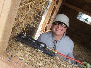 woman building straw bale house