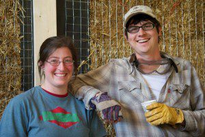 couple in front of straw bale wall