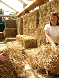 Woman building a straw bale house
