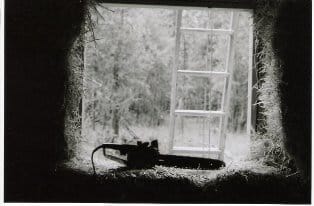 chainsaw in straw bale house window
