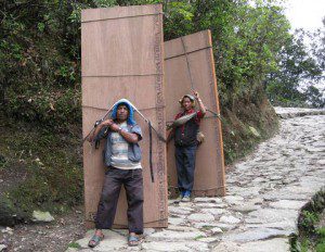 two men carrying plywood