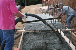 men pouring a concrete foundation