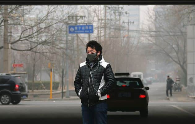 Chinese man walking in smog