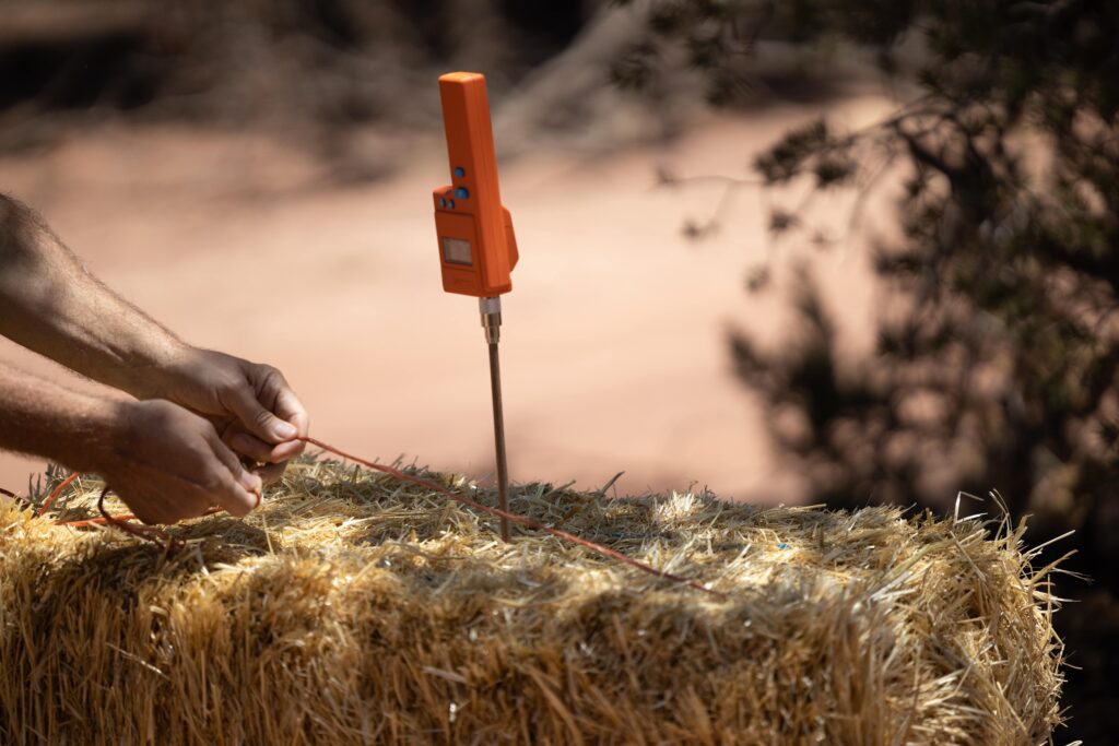 moisture meter in use at a straw bale workshop