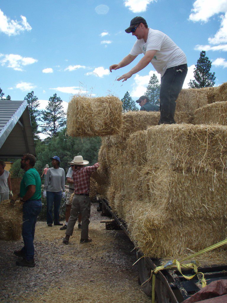 unloading straw bales from a trailer