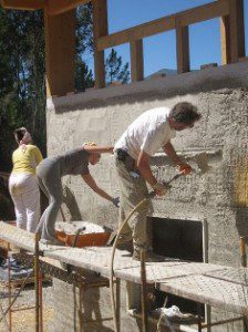 Andrew Morrison and friends applying plaster to straw bale walls