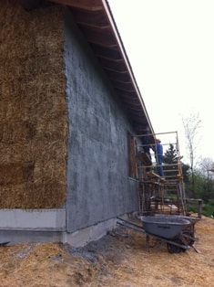 straw bale house with one wall plastered