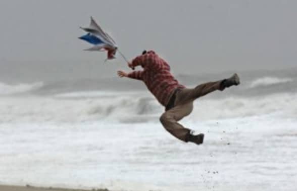 man being pulled by wind