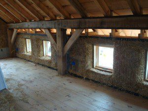 exposed timber frame straw bale house