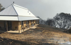 Wildland fires almost burns straw bale house
