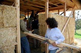 woman building straw bale house