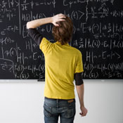 Person standing in front of chalk board